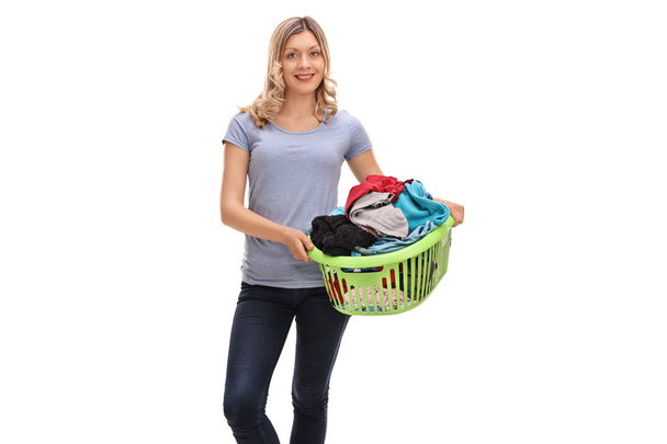 Woman holding a laundry basket - 写真・画像