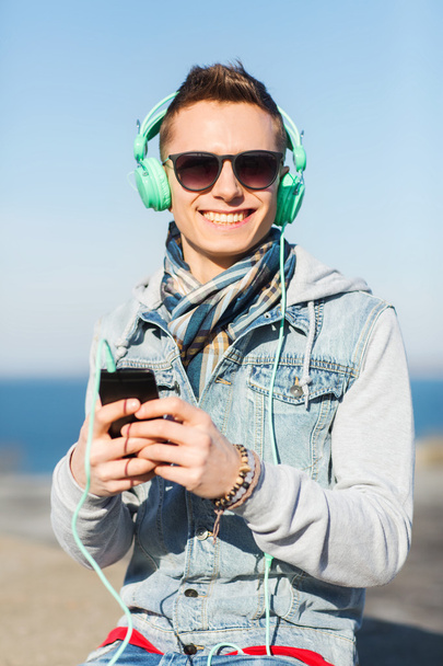 happy young man in headphones with smartphone - Photo, image