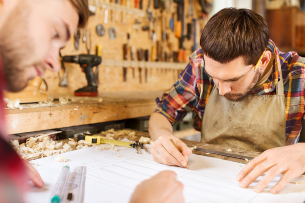 carpenters with ruler and blueprint at workshop - Foto, Bild