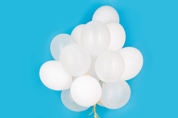 close up of white helium balloons over blue - Fotografie, Obrázek