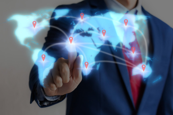 Businessman touching blue virtual world map on screen with conne - Zdjęcie, obraz
