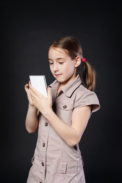 Portrait of serious girl touch screen on mobile phone - Photo, Image