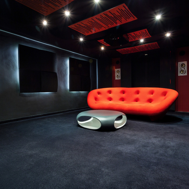 Red sofa in dark room - Фото, зображення