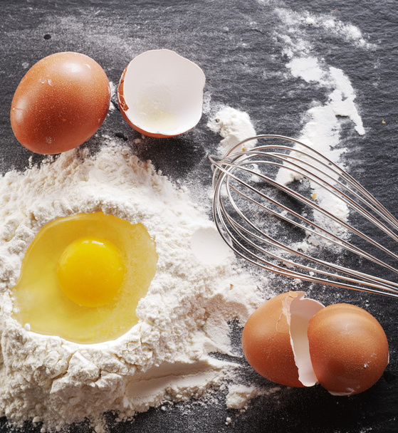 Dough preparation. Baking ingredients: egg and flour.  - Foto, Bild
