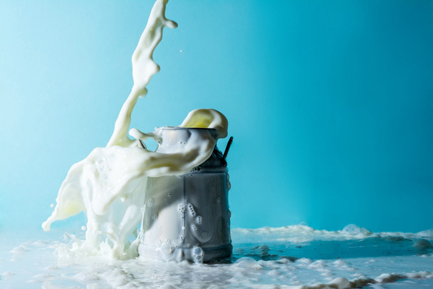 Splashes of milk, stream jet of milk pours pouring into a can of milk  - Foto, immagini