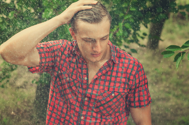 Sexy young man wet in rain - Photo, image