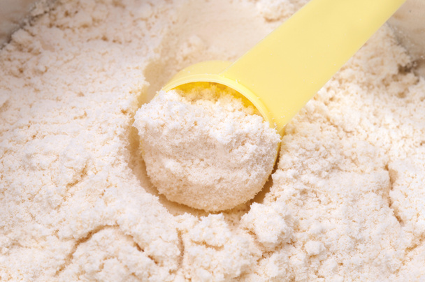 close up of powdered milk and spoon for baby on white background - Foto, immagini