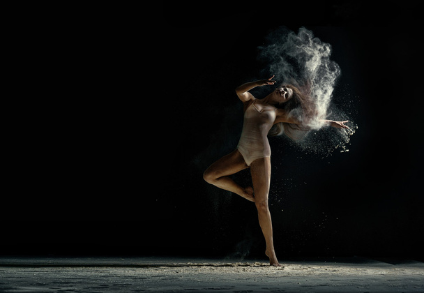 Amazing photo of graceful woman dancing with dust - Φωτογραφία, εικόνα