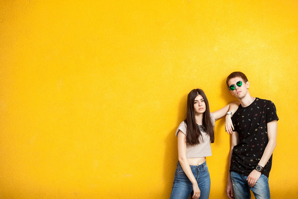 Couple posing in fashion jeans style to the camera - Foto, afbeelding