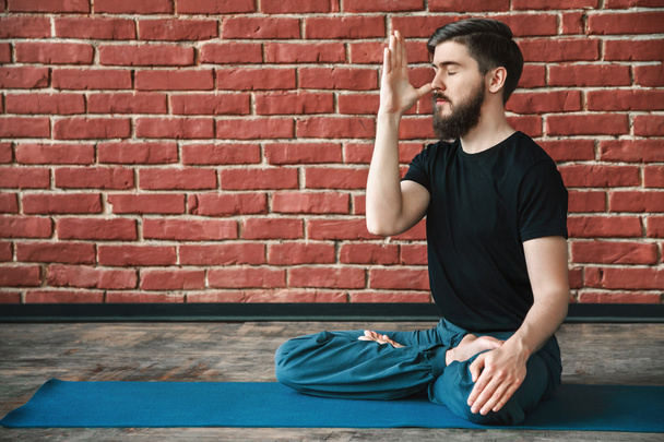 Handsome man doing yoga positions - Photo, Image