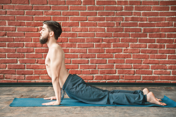 Young man practice yoga - Zdjęcie, obraz