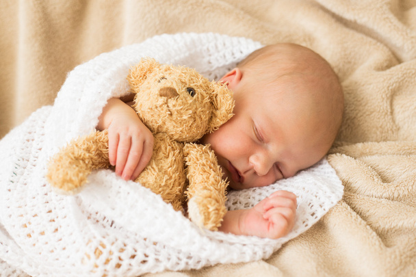 Infant sleeping together with teddy bear - Fotografie, Obrázek
