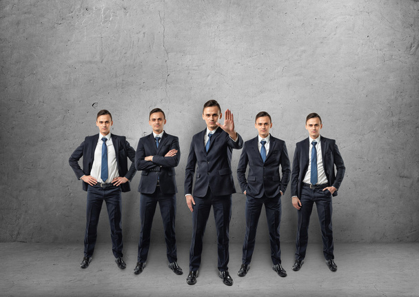 Five full-lenght businessmen standing in different poses isolated on the white background - Photo, image