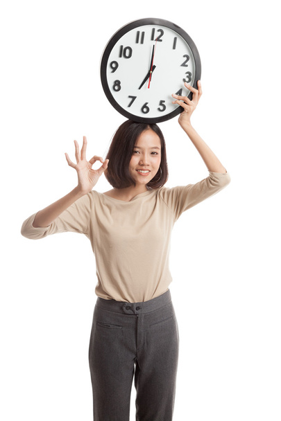 Young Asian business woman show OK with a clock - Photo, Image