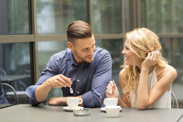 Beautiful couple having coffee on a date - Zdjęcie, obraz