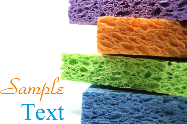 Purple blue orange and green sponges with copy space - Photo, Image