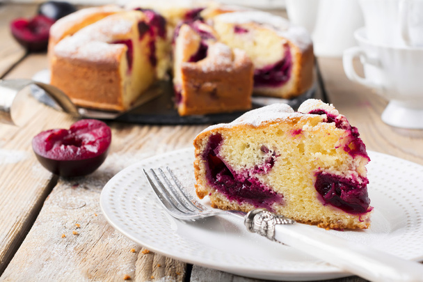 Plum cake on an old wooden table. Rustic style. Selective focus. - Photo, Image