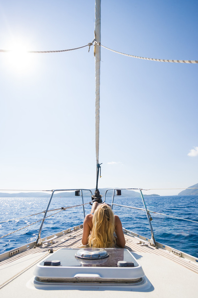 Beautiful female tanning on the yacht - Zdjęcie, obraz