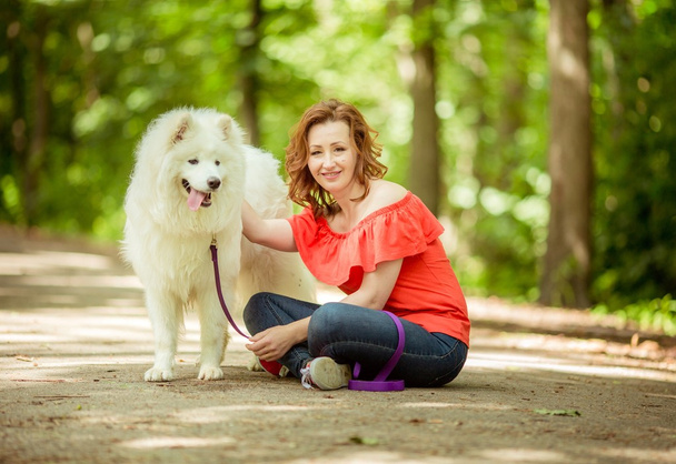Woman with Samoyed dog breed in the park - Photo, Image