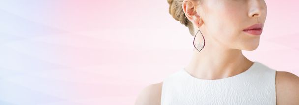 close up of beautiful woman face with earring - Foto, afbeelding