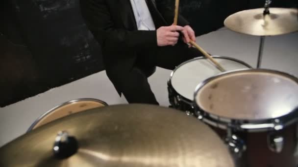 Man in black suit and sunglasses plays on drum. Rock cover band performing on stage with drummer - Footage, Video