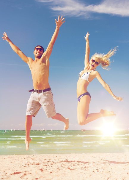 couple jumping on the beach - Photo, Image