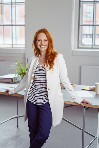 Relaxed happy businesswoman in her office - Foto, afbeelding