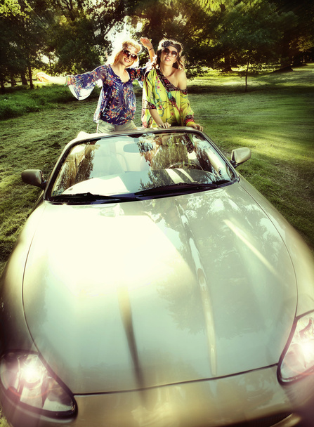 Smiling women in a cabriolet - 写真・画像