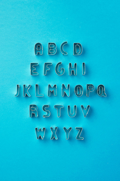Alphabet letters organized over blue  - Zdjęcie, obraz