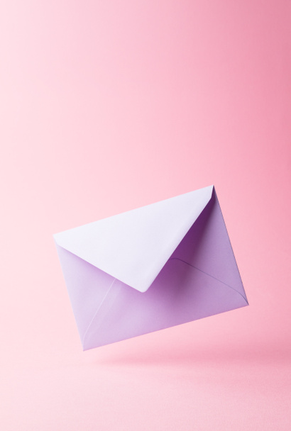 Purple envelope dropped over pink - Photo, Image