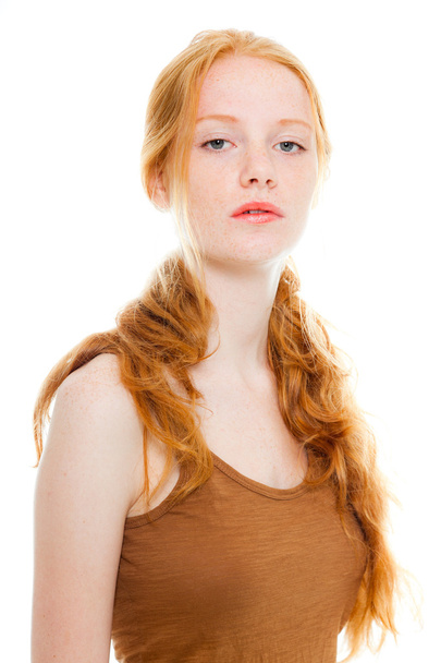 Pretty girl with long red hair wearing brown shirt. Fashion studio shot isolated on white background. - Foto, Bild