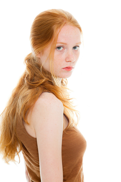 Pretty girl with long red hair wearing brown shirt. Fashion studio shot isolated on white background. - Zdjęcie, obraz