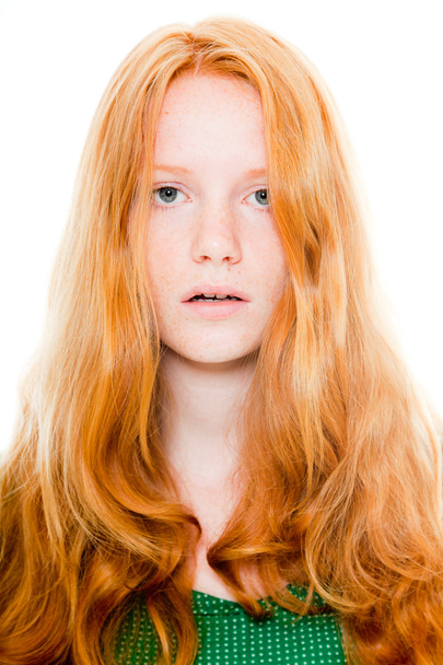 Pretty girl with long red hair wearing green shirt. Natural beauty. Fashion studio shot isolated on white background. - Foto, Bild