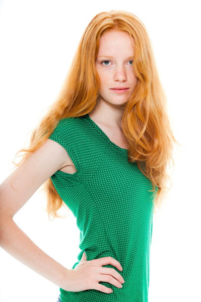 Pretty girl with long red hair wearing green shirt. Natural beauty. Fashion studio shot isolated on white background. - Фото, зображення
