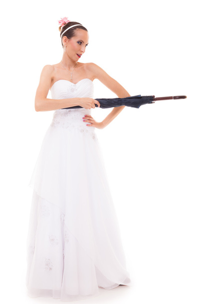 Full length bride in wedding gown holds umbrella - Foto, Imagen