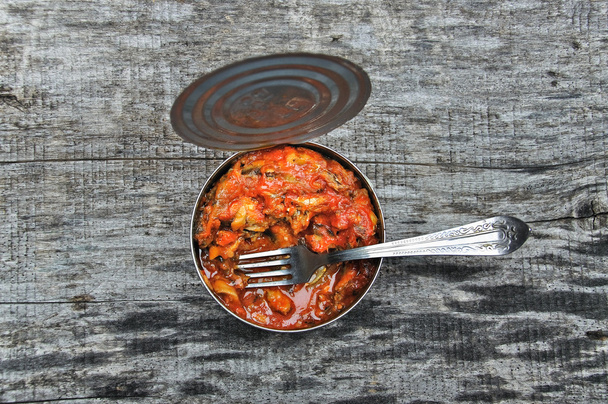 Open cans with fried sprats in tomato sauce - Photo, Image