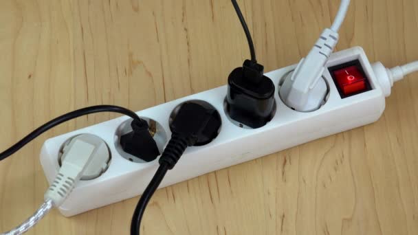 woman hands turn off electricity extension switch with many plugs. - Materiał filmowy, wideo