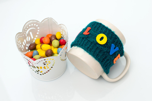 Colorful candy in a pot on a white background with cup holders a - Photo, Image