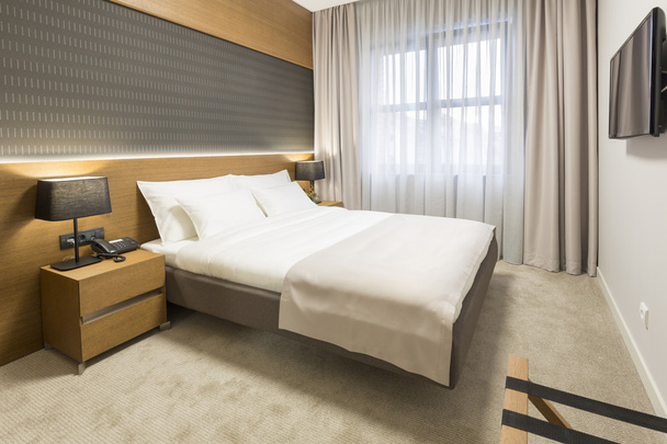 Interior of a new modern hotel bedroom - Photo, Image