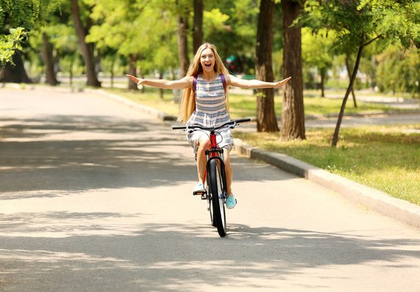 Beautiful girl riding bike  - Фото, зображення