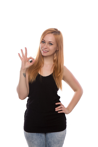 young beautiful girl with red hair shows the gesture isolated on white background - Fotó, kép