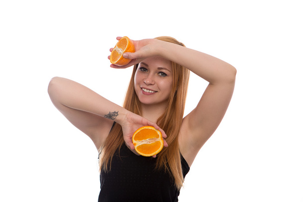 young beautiful girl with red hair holding orange in hand isolated on white background - Foto, Imagen