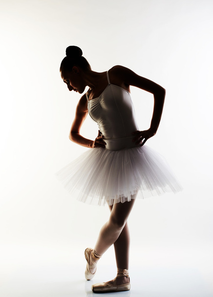 Ballerina performing a dance against a white background - Foto, imagen
