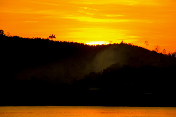 sunset behind the mountain with boat running along the river san - Photo, Image