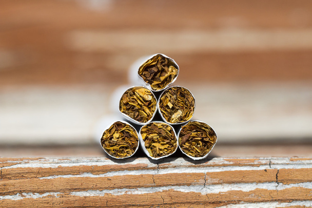 Close-up of Tobacco Cigarettes on wood surface. Background or texture - Photo, Image