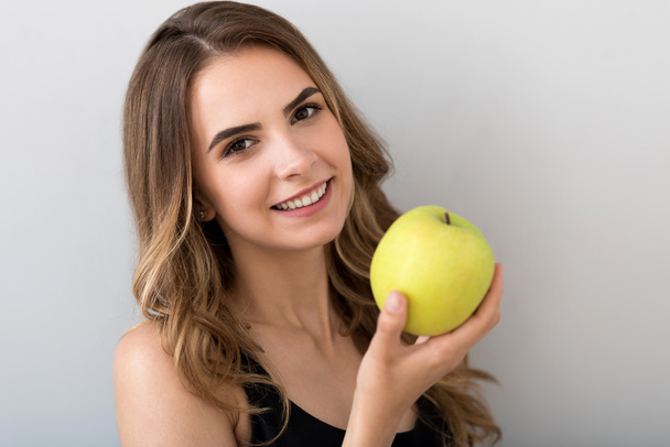 Cheerful smiling woman holding apple - Photo, Image