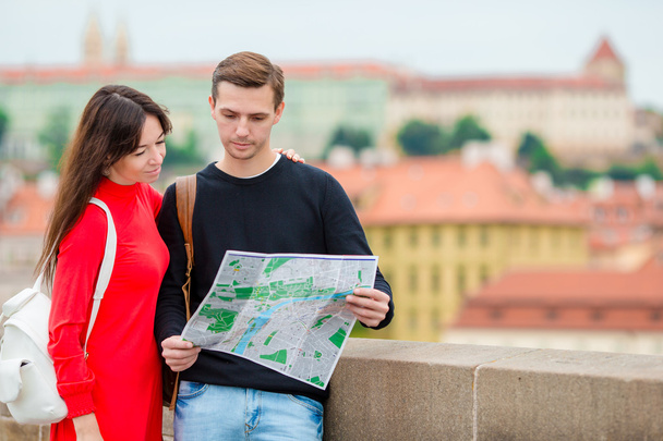 Romantic couple walking together in Europe. Happy lovers enjoying cityscape with famous landmarks. Stylish urban young man and woman with backpacks on travel in Prague - Foto, immagini