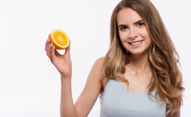 Cheerful woman holding orange - Zdjęcie, obraz
