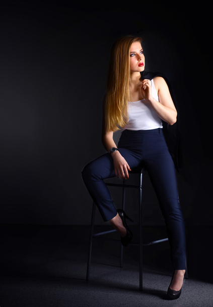 Young woman sitting on a chair - Zdjęcie, obraz