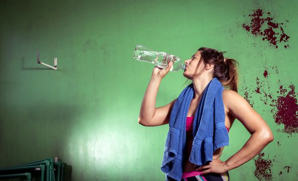 GIrl drinking water after training - Photo, image